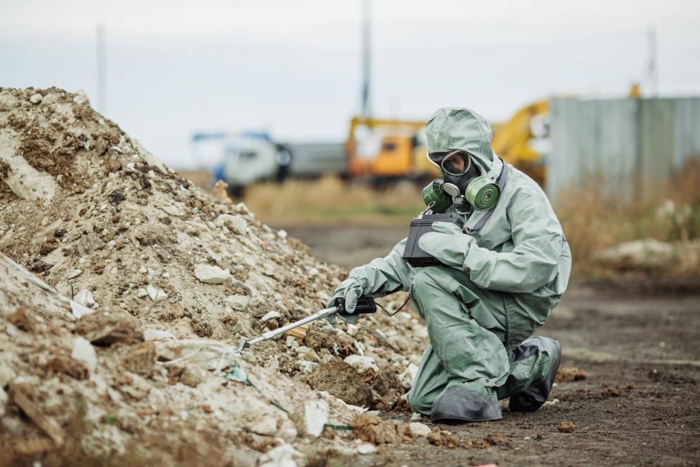Scientist (radiation supervisor) in protective clothing and gas