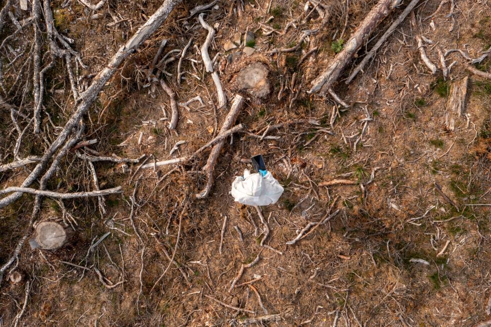 Aerial view above emergency personnel among destruction